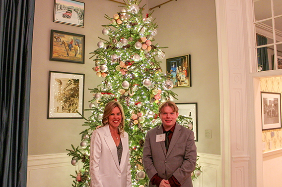 The First Lady and artist Joey Frye pose in front of a Christmas tree.